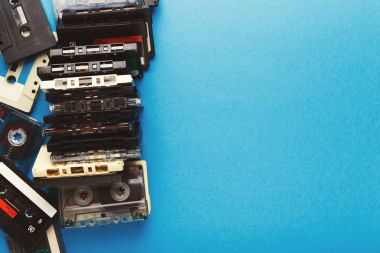 Vintage audio cassettes border on blue background clipart