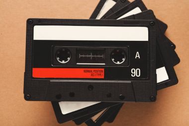 Vintage audio cassettes on brown background clipart
