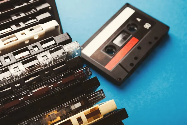 Vintage audio cassettes border on blue background