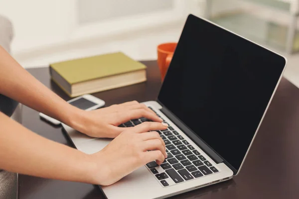 Ugjenkjennelige jenter med bærbar PC sittende på sofaen – stockfoto