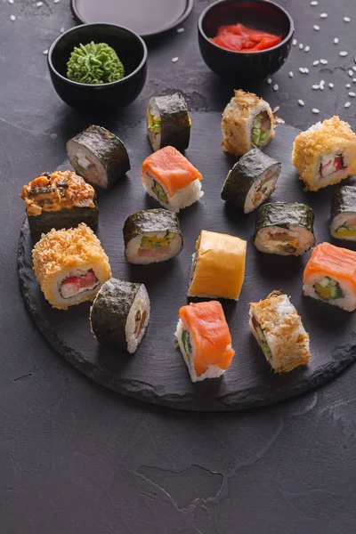 Set of sushi maki and rolls on gray background — Stock Photo, Image