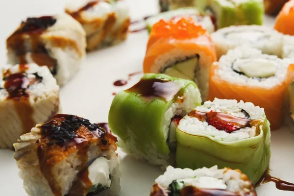 Set of sushi rolls, maki with unagi sauce on white — Stock Photo, Image
