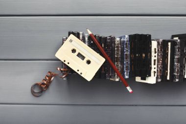 Vintage kaset ve kalem gri ahşap zemin üzerine teyp geri sarmak için