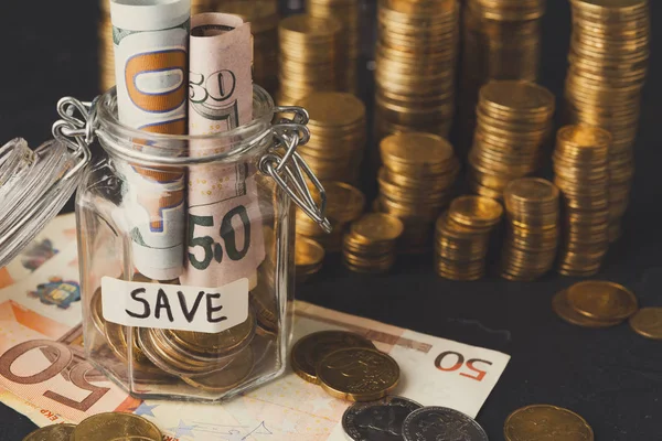 Coins in glass jar for money saving, copy space