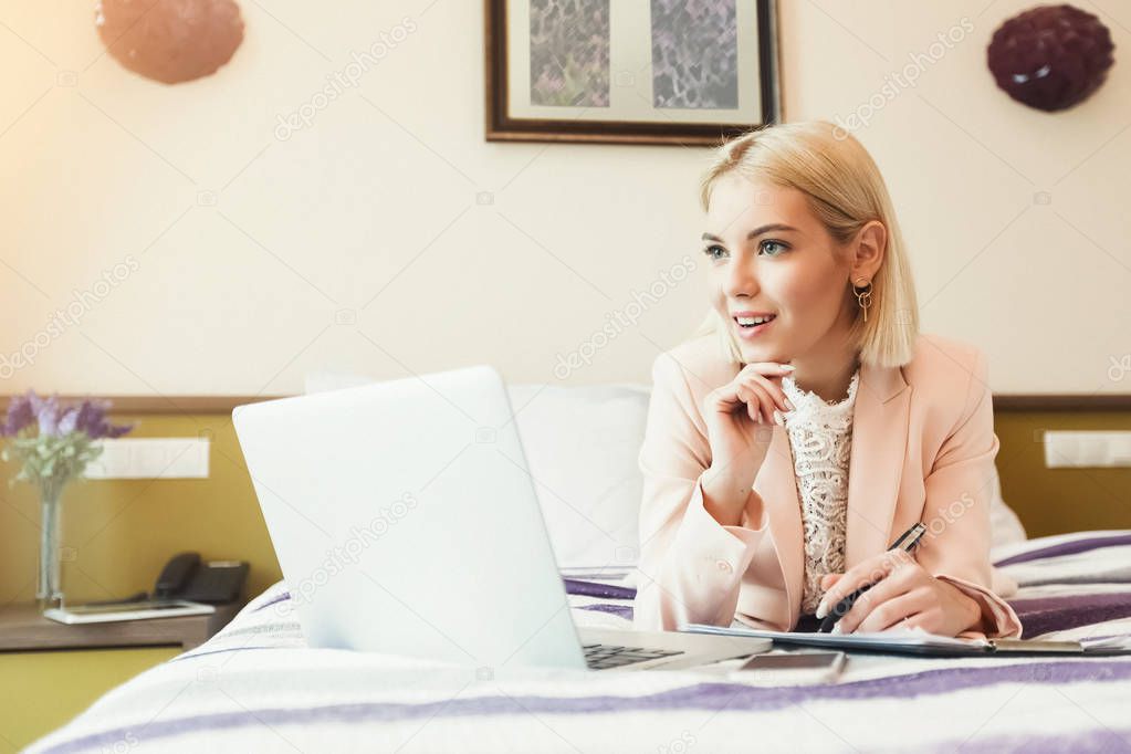 Thoughtful businesswoman working with documents in hotel