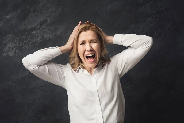 Businesswoman posing to camera and shouting