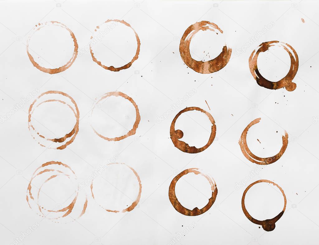 Collection of dry coffee cup stains on white background