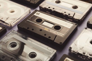 Vintage audio cassettes on violet background, closeup clipart