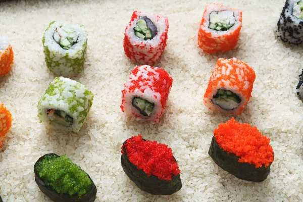 Closeup of sushi rolls and gunkan on rice — Stock Photo, Image