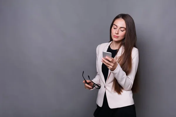 Pensive брюнетка бізнес леді використовує мобільний телефон — стокове фото