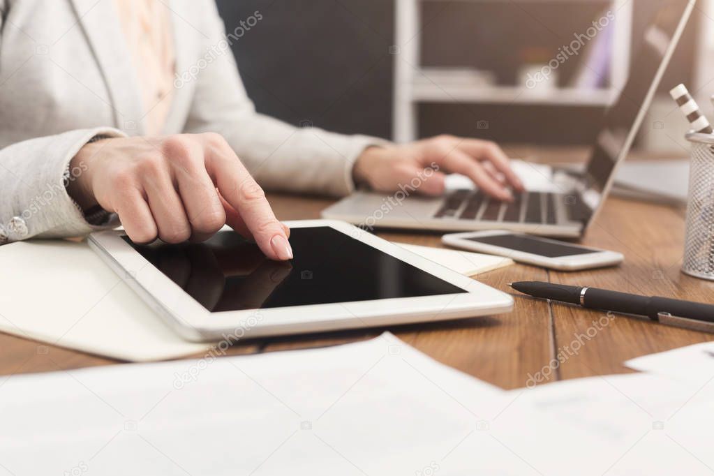 Woman pointing on digital tablet close up