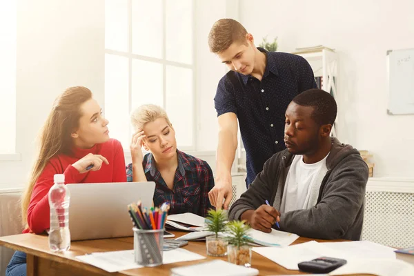 Multiethnic classmates preparing for exams together — Stock Photo, Image