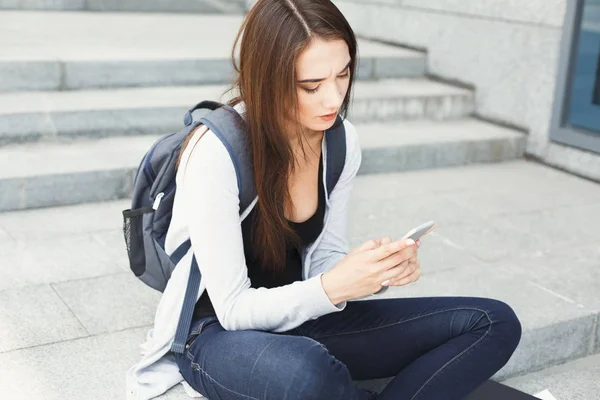 Mujer joven utilizando el teléfono inteligente al aire libre —  Fotos de Stock