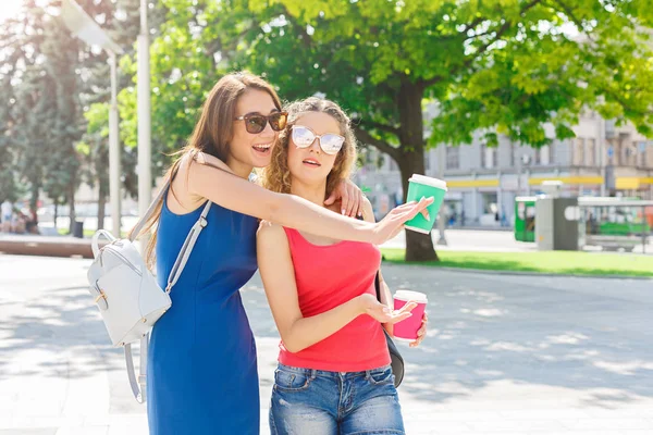 Happy girls with take away coffee outdoors — Stock Photo, Image