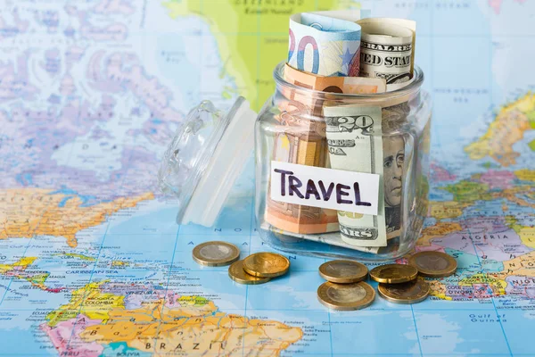 Travel budget concept. Money saved for vacation in glass jar on map — Stock Photo, Image