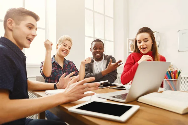 Group of diverse students studying at wooden table — Stock Photo, Image