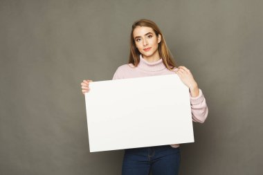Young smiling woman with blank white paper
