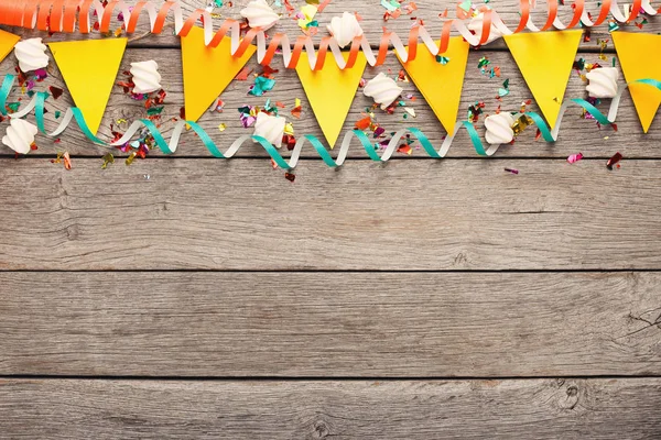 Colorful flags garland on wooden background — Stock Photo, Image