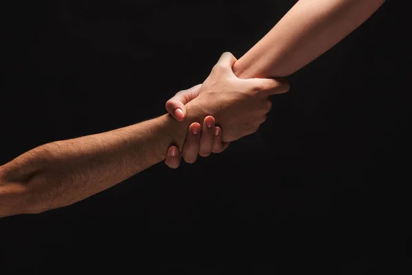 Händerna på man och kvinna i kärlek, isolerade på svart — Stockfoto