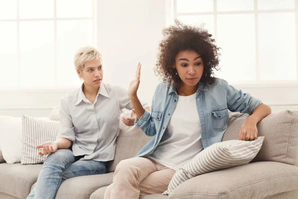 Två väninnor sitter på soffan och argumentera — Stockfoto