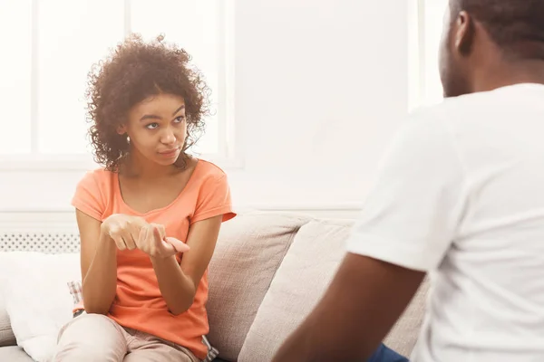 Emozionale coppia nera parlando sul divano a casa — Foto Stock