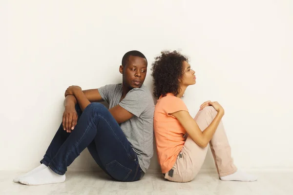 Casal preto sentado no chão no novo apartamento — Fotografia de Stock