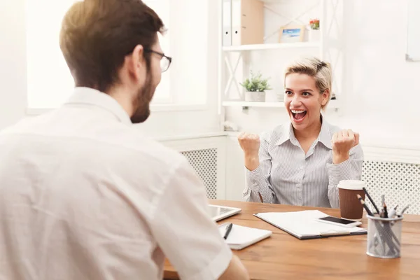 Young happy business partners in office with computer — Stock Photo, Image