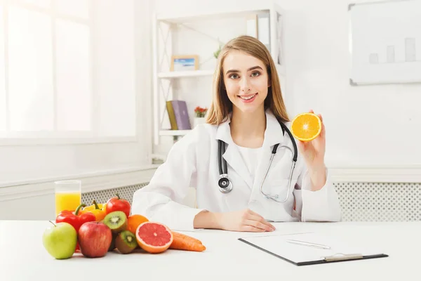 Dietitian nutritionist with fresh orange