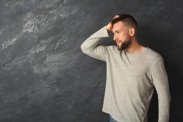 Handsome thoughtful man posing in studio — Stock Photo, Image