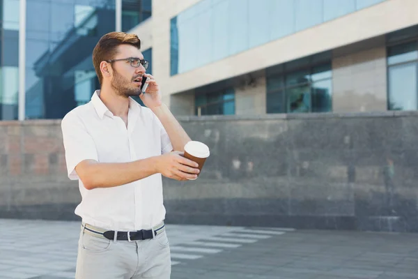 Young serious businessman making a call outdoors — Stock Photo, Image