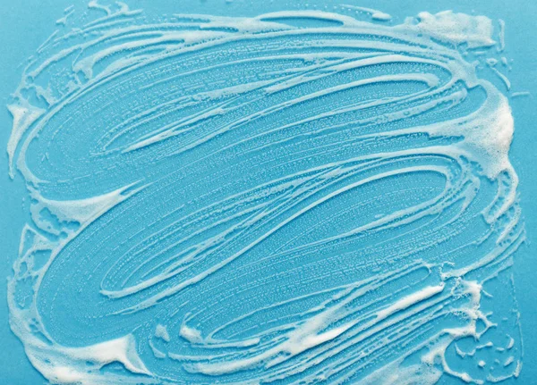 Espuma detergente no fundo de vidro — Fotografia de Stock