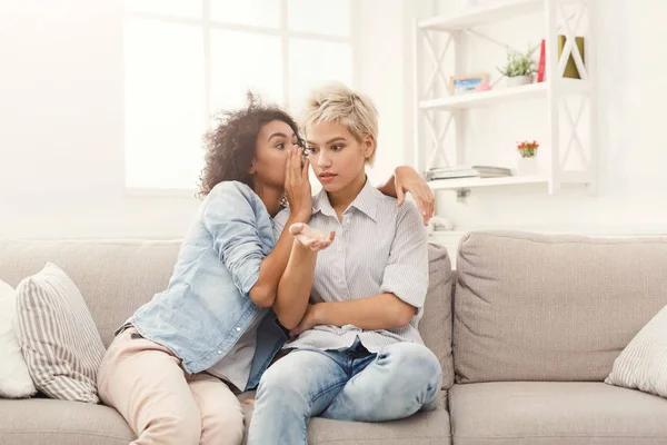 Young woman telling her friend some secrets — Stock Photo, Image