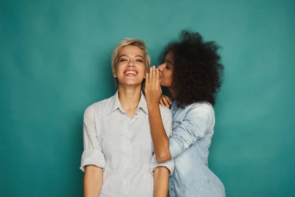 Young woman telling her friend some secrets — Stock Photo, Image