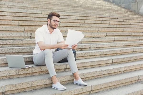 Hombre de negocios pensativo leyendo los documentos al aire libre — Foto de Stock