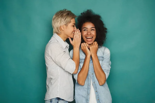 Young woman telling her friend some secrets — Stock Photo, Image