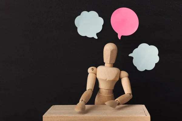 Wooden man mannequin with blank speech bubbles — Stock Photo, Image