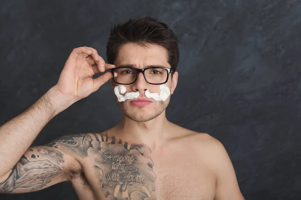 Young sexy tattooed man with moustaches from foam — Stock Photo, Image