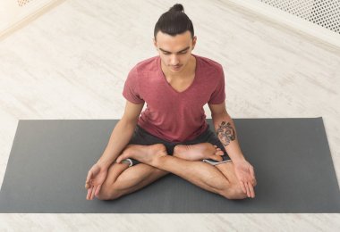 Genç adam pratik yoga, meditasyon poz sakin ol