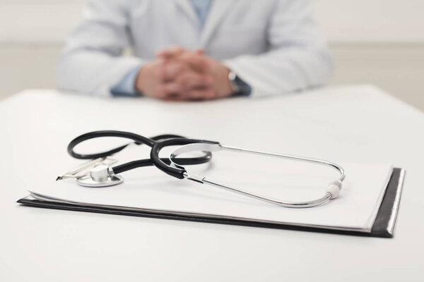 Stethoscope on desk, selective focus, closeup