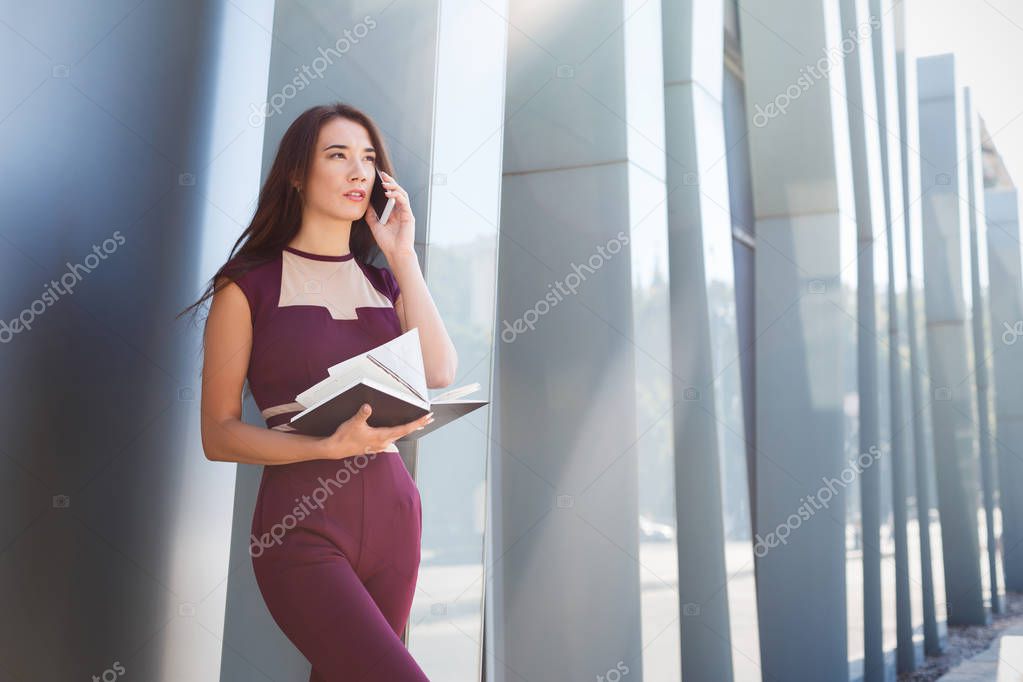 Businesswoman talking on smartphone outdoors