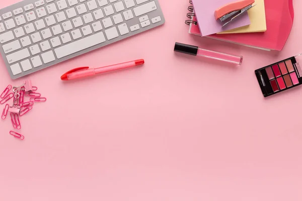 Рабочее место с клавиатурой на розовом фоне — стоковое фото