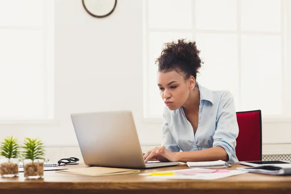在办公室工作的严肃的商业妇女在膝上型电脑 — 图库照片
