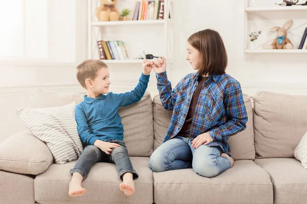 Children making peace with little fingers