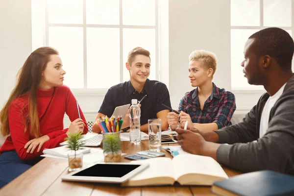 Group of diverse students studying at wooden table — Stock Photo, Image