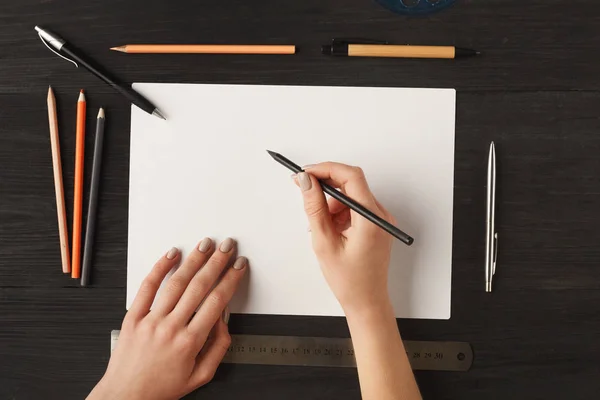 Mujeres manos dibujo sobre papel en blanco, vista superior — Foto de Stock