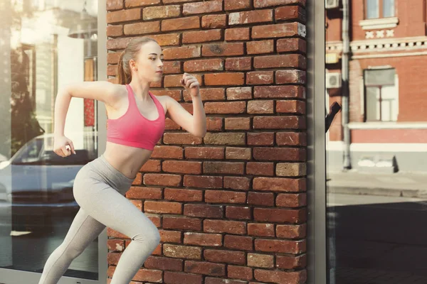 Young woman jogging in city copy space — Stock Photo, Image