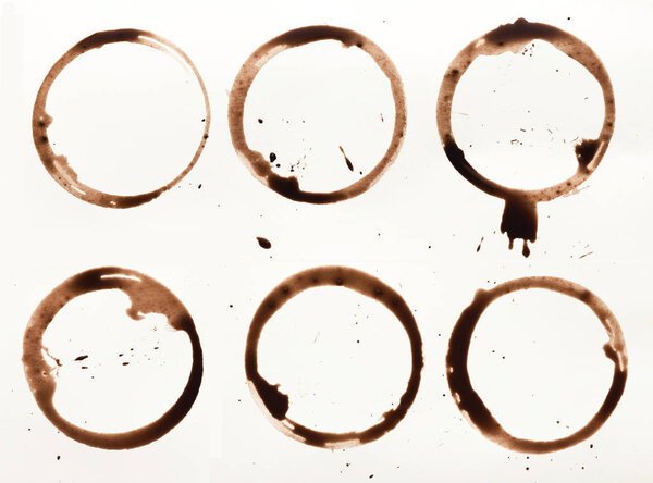 Collection of dry coffee cup stains on white background