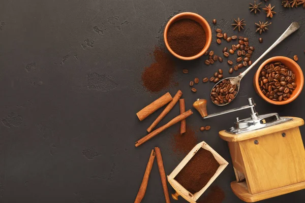 Top view on old coffee mill, scattered beans and spices, background with copy space — Stock Photo, Image