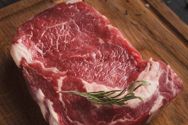 Raw beef filet mignon steak on wooden board — Stock Photo, Image