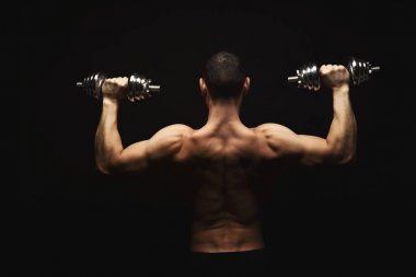 Dumbbell aidatı çıplak kas vücut ile güçlü atletik erkek